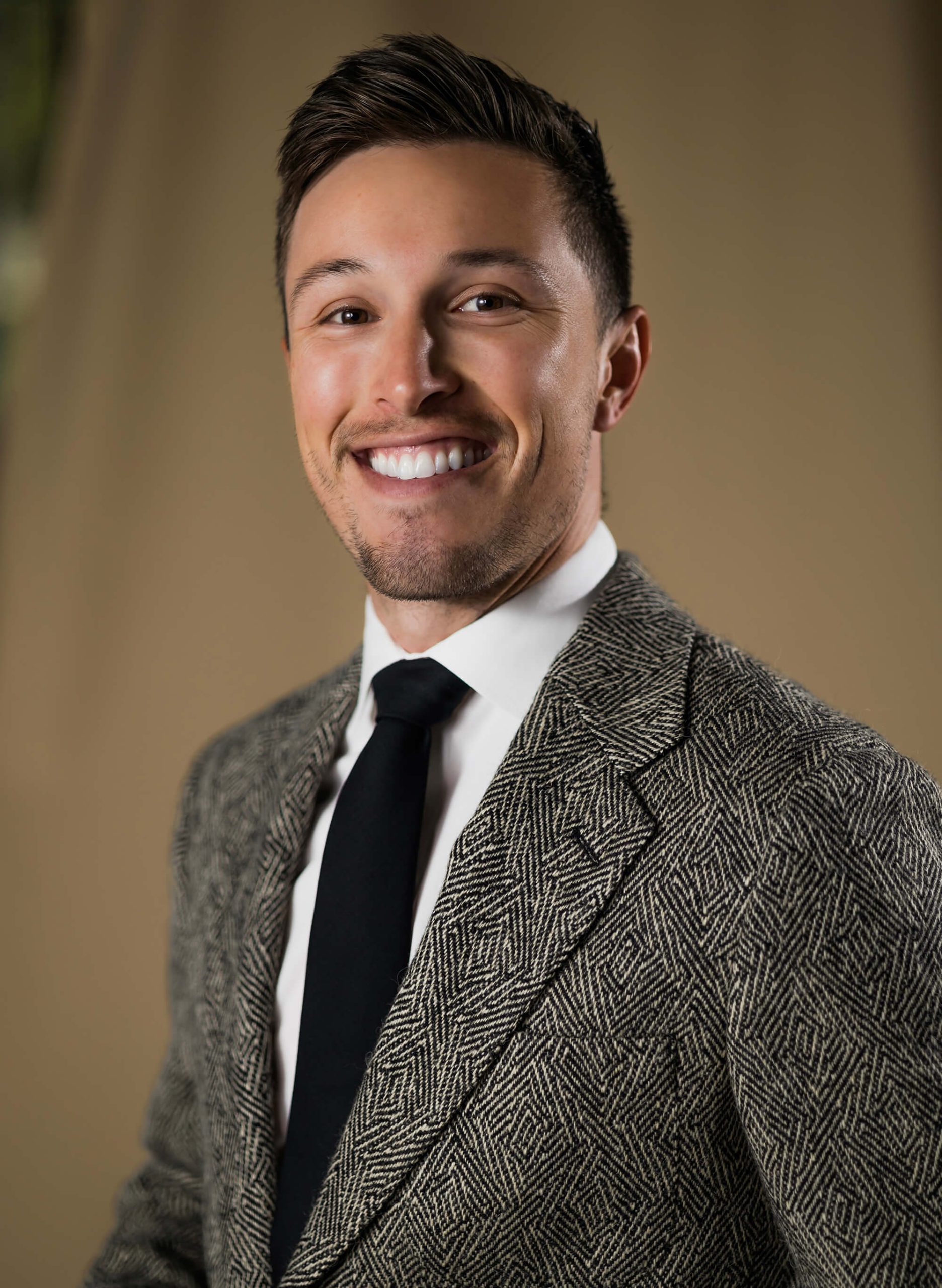 Dr. Connor Perrin, dentist in Irvine, smiling for a picture at his dental office, The Tooth Co.