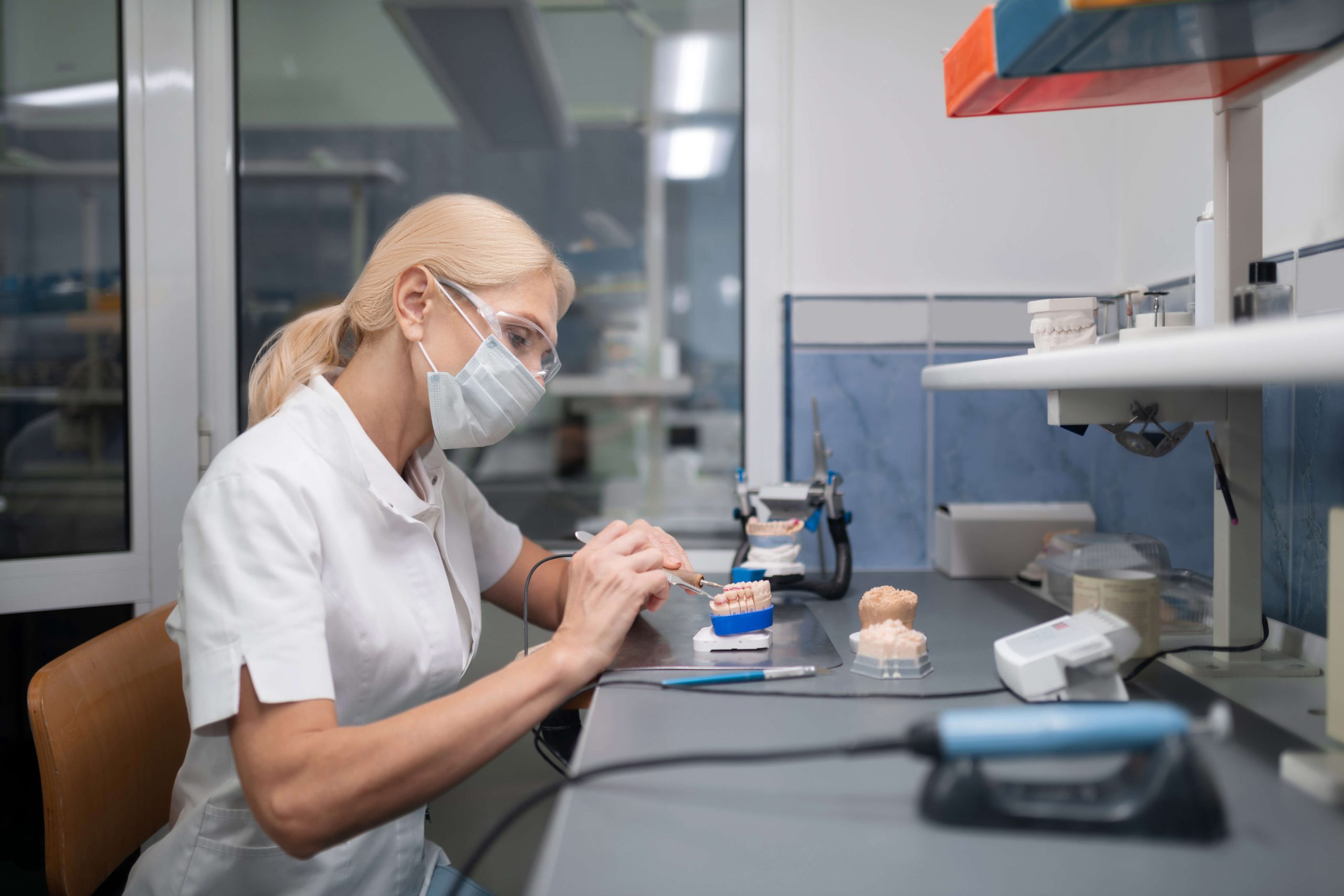 Skilled ceramist expertly crafting veneers for our cosmetic dentist in Irvine.