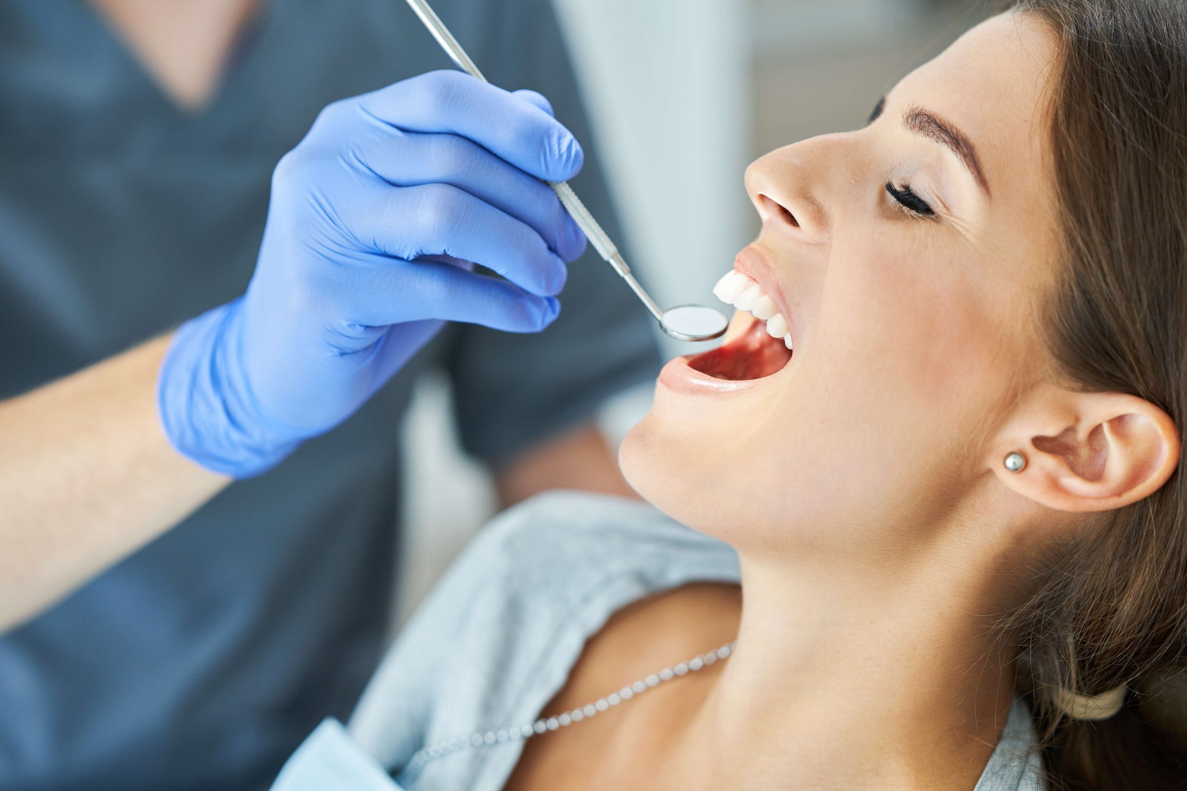 A cosmetic dentist in Irvine prepping the teeth for porcelain veneers