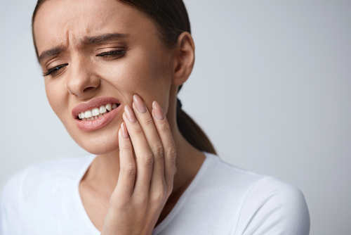 A patient experiencing toothache in need of an emergency dentist in Irvine, CA