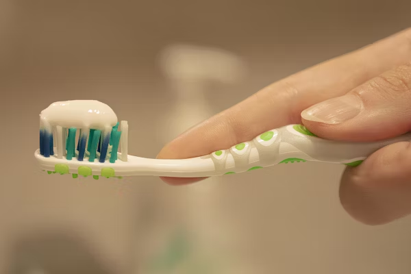 image showing a toothbrush with toothpaste on it